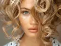 Blondynka z piegami i artystycznymi lokami. Jak zrobić loki, by uzyskać taki efekt?